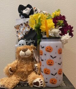 Festive Boo Box Halloween care package with treats, fuzzy socks, cup, Plush Bear, and optional flower arrangement, hand-delivered in Iowa City
