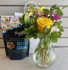 A thoughtful care package with flowers, a treat, and a balloon — perfect for any occasion.