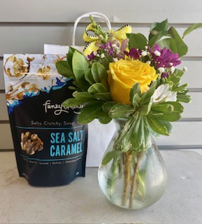 A thoughtful care package with flowers, a treat, and a balloon — perfect for any occasion.