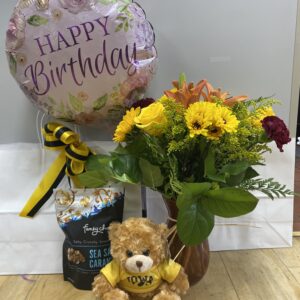 Deluxe student care package with large flower arrangement, Iowa bear, balloon, and sweet treat.