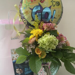 Medium student care package with fresh flowers, balloon, and sweet treat, hand-delivered in Iowa City.